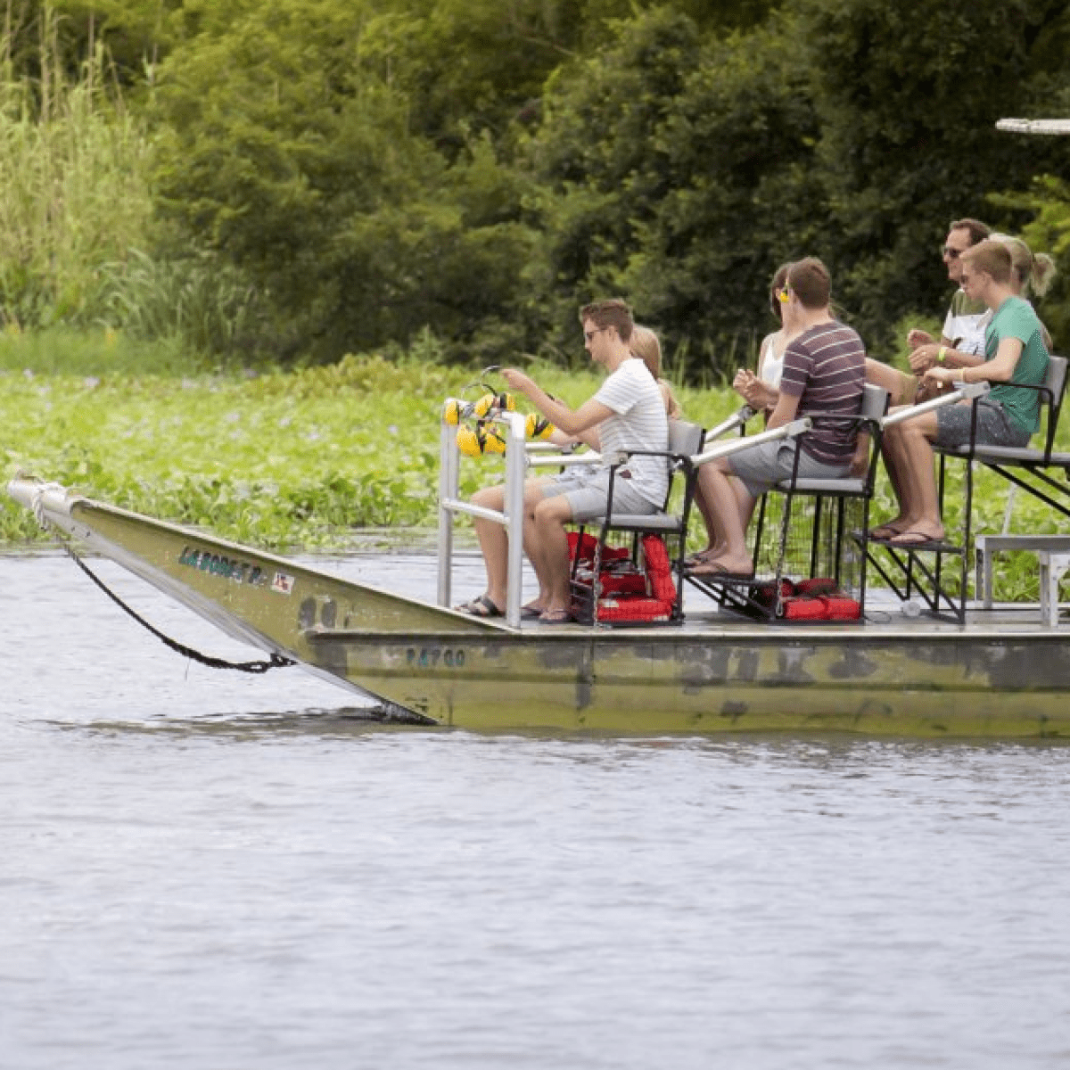 a group of people riding on the back of a boat
