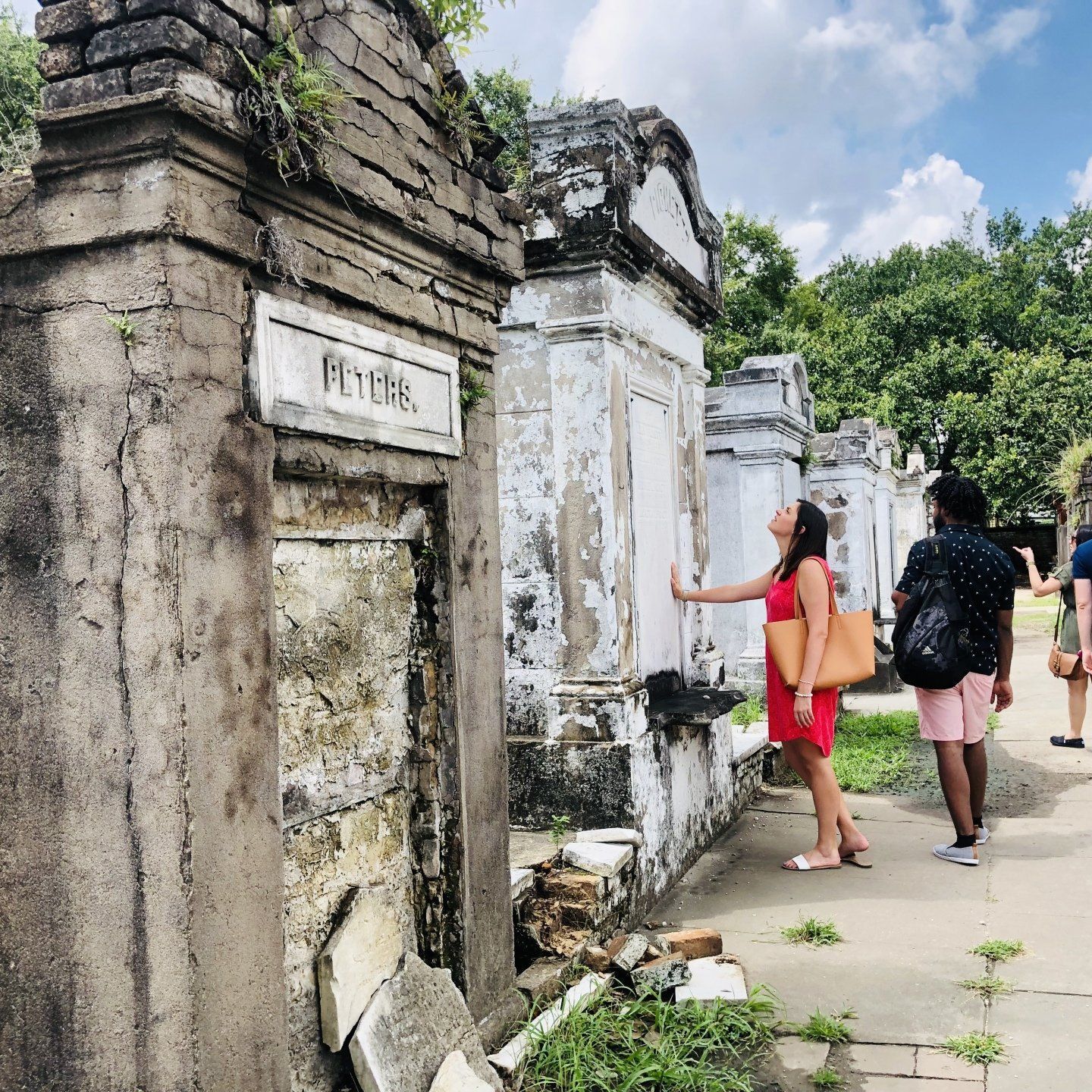 a group of people standing in front of a stone building