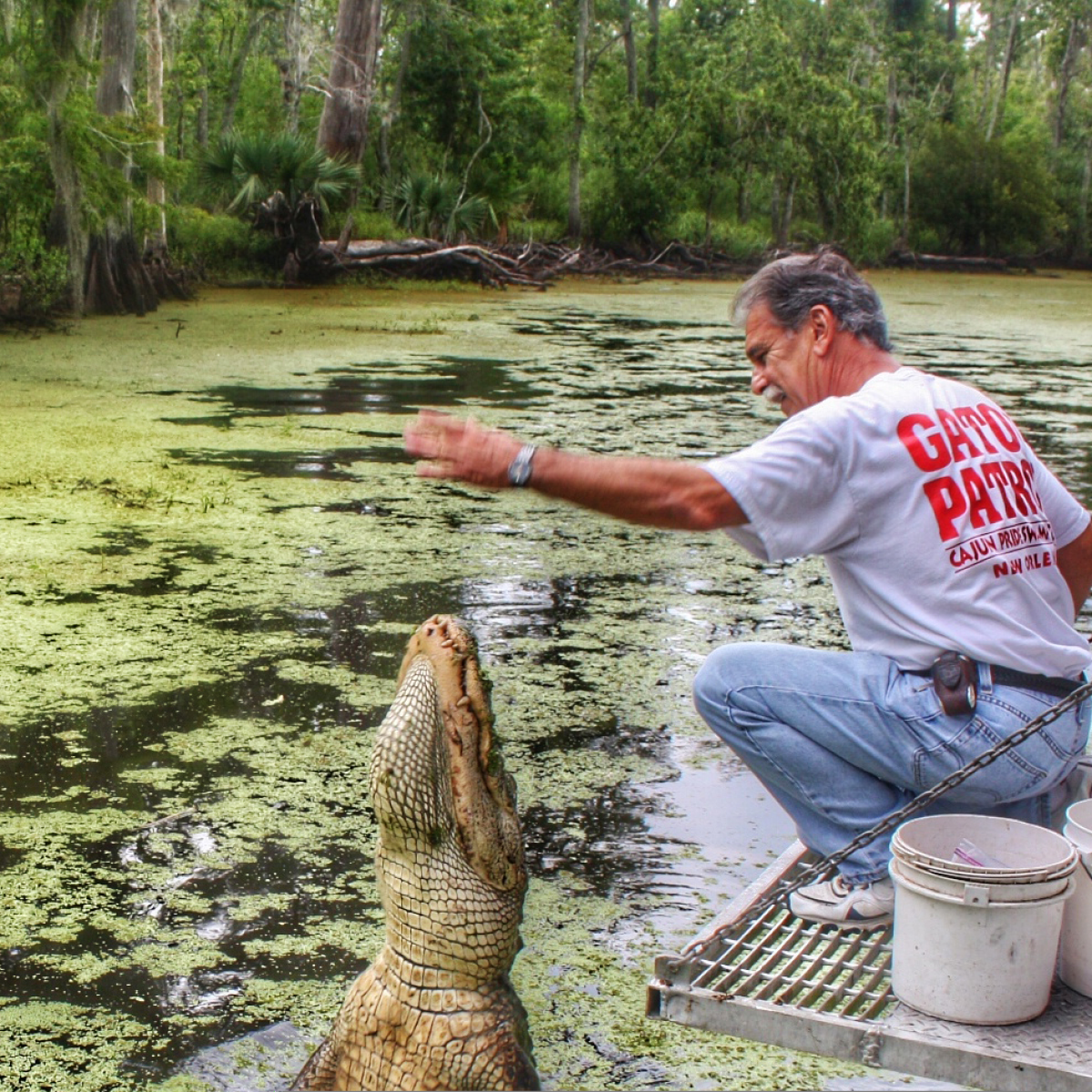 a man holding a frisbee in the water