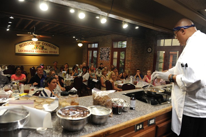 Chef teaching cooking class at Louisiana General Store to an attentive audience.