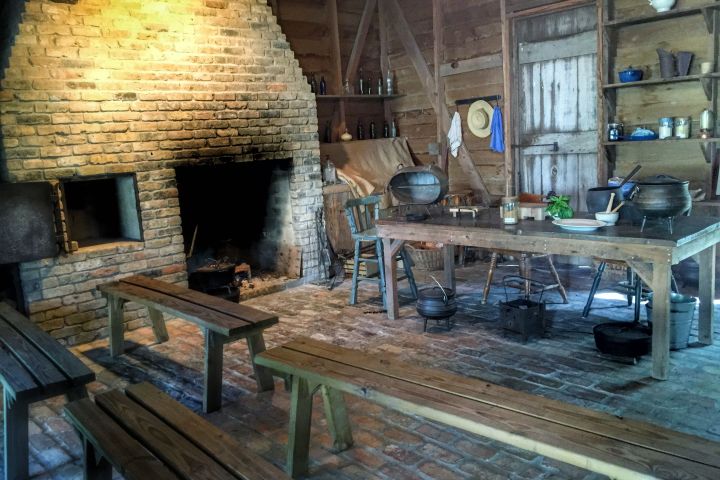 a stone bench next to a fireplace